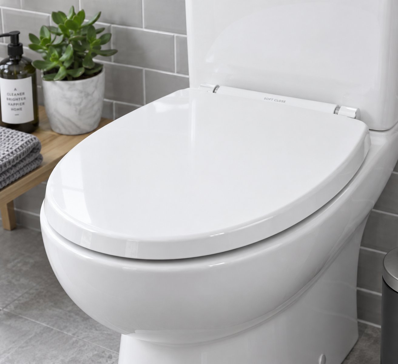 a modern polypropylene (pp) toilet seat showcasing its smooth non porous surface and sleek soft close hinge design